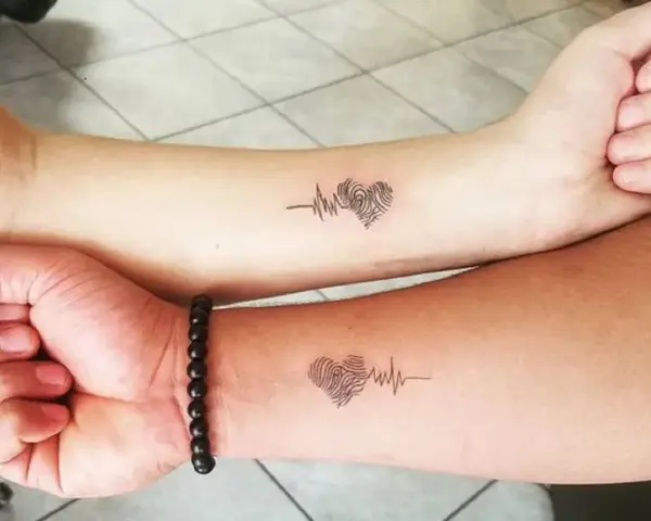 Dwa identyczne tatuaże sióstr: serce z odcisku palca i linia EKG. Symbol nierozerwalnej więzi.